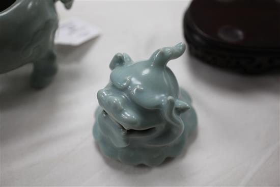 A Chinese celadon-glazed lion-dog censer and cover, 18th century, 17.2cm, wood stand